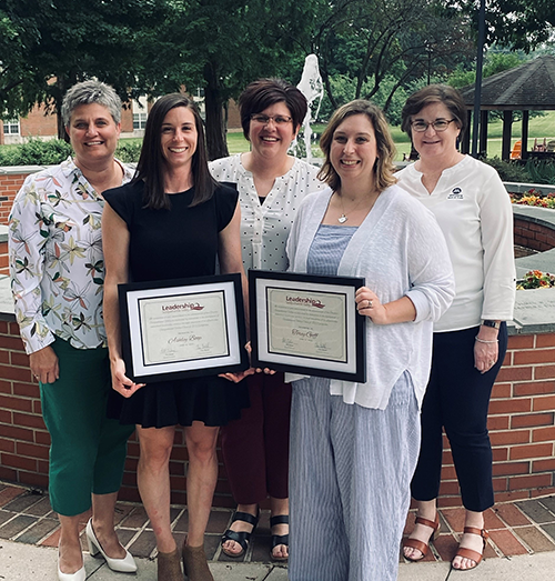 Ashley Boop and Torey Goff pose with Lisa Erickson, Mandi Ruhl, and Shelby Hackenberg, all employees of Mifflinburg Bank, for Boop and Goff's Leadership Susquehanna Valley graduation